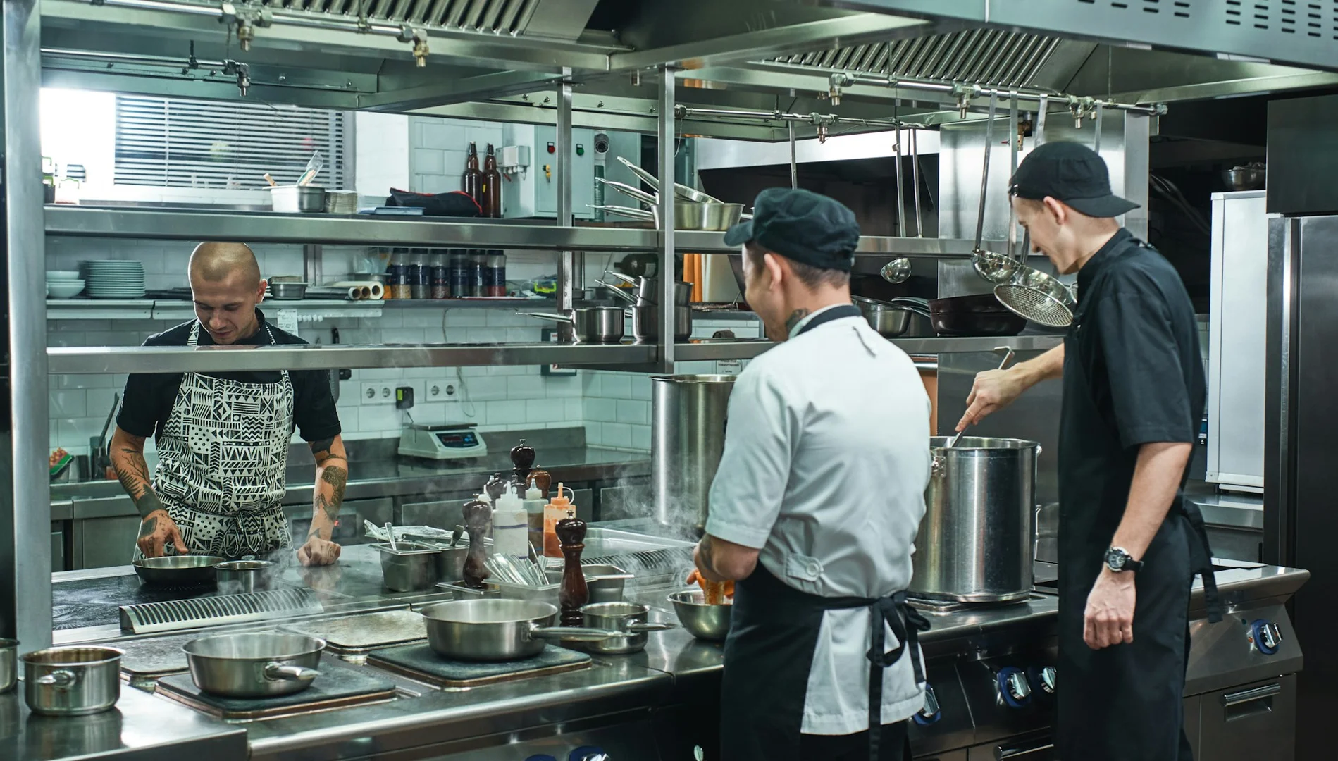 Local Calgary restaurant staff preparing meals in a commercial kitchen for school lunch programs.