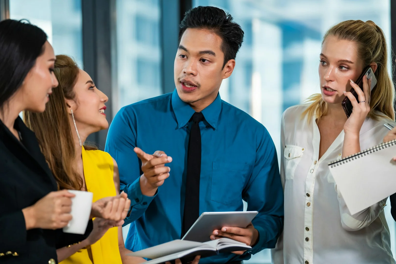 School or parent council members using a tablet to manage hot lunch fundraising online.