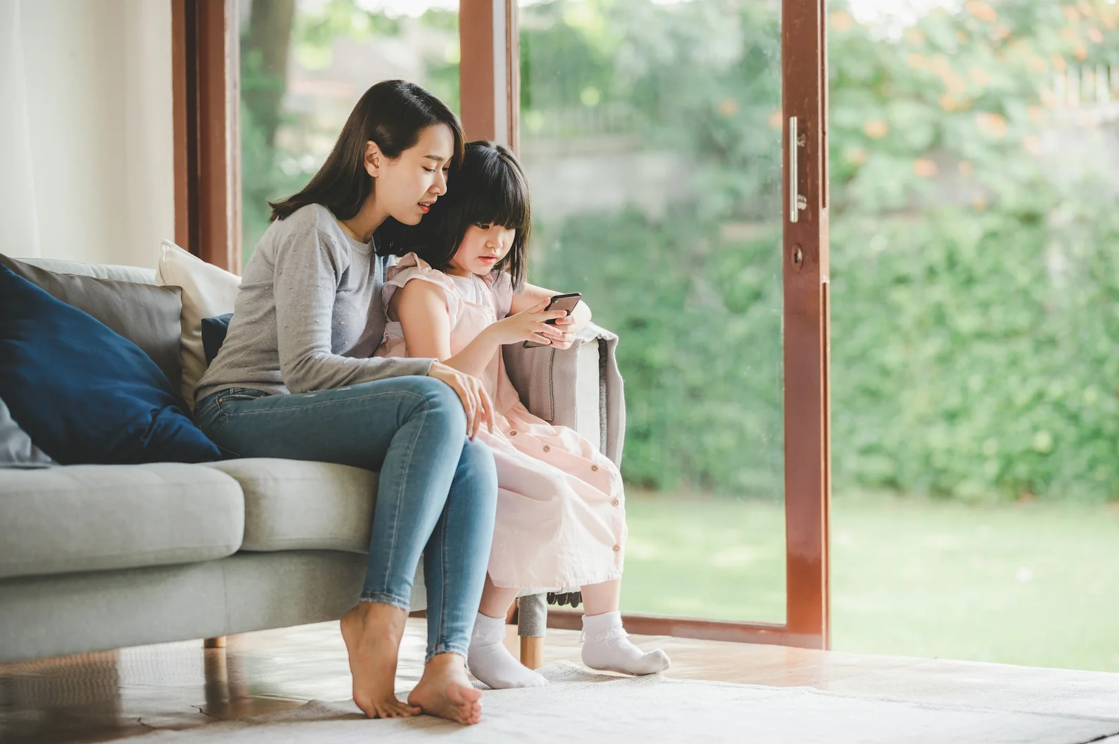 Parent and child checking school lunch options on a phone for easy meal ordering.