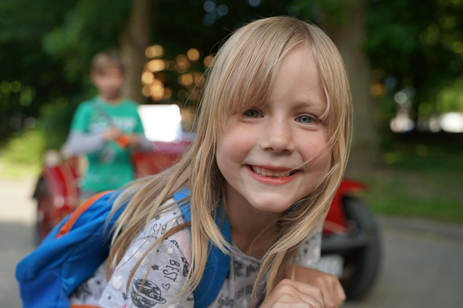 Smiling young student wearing a backpack, representing safe and reliable school lunch planning.