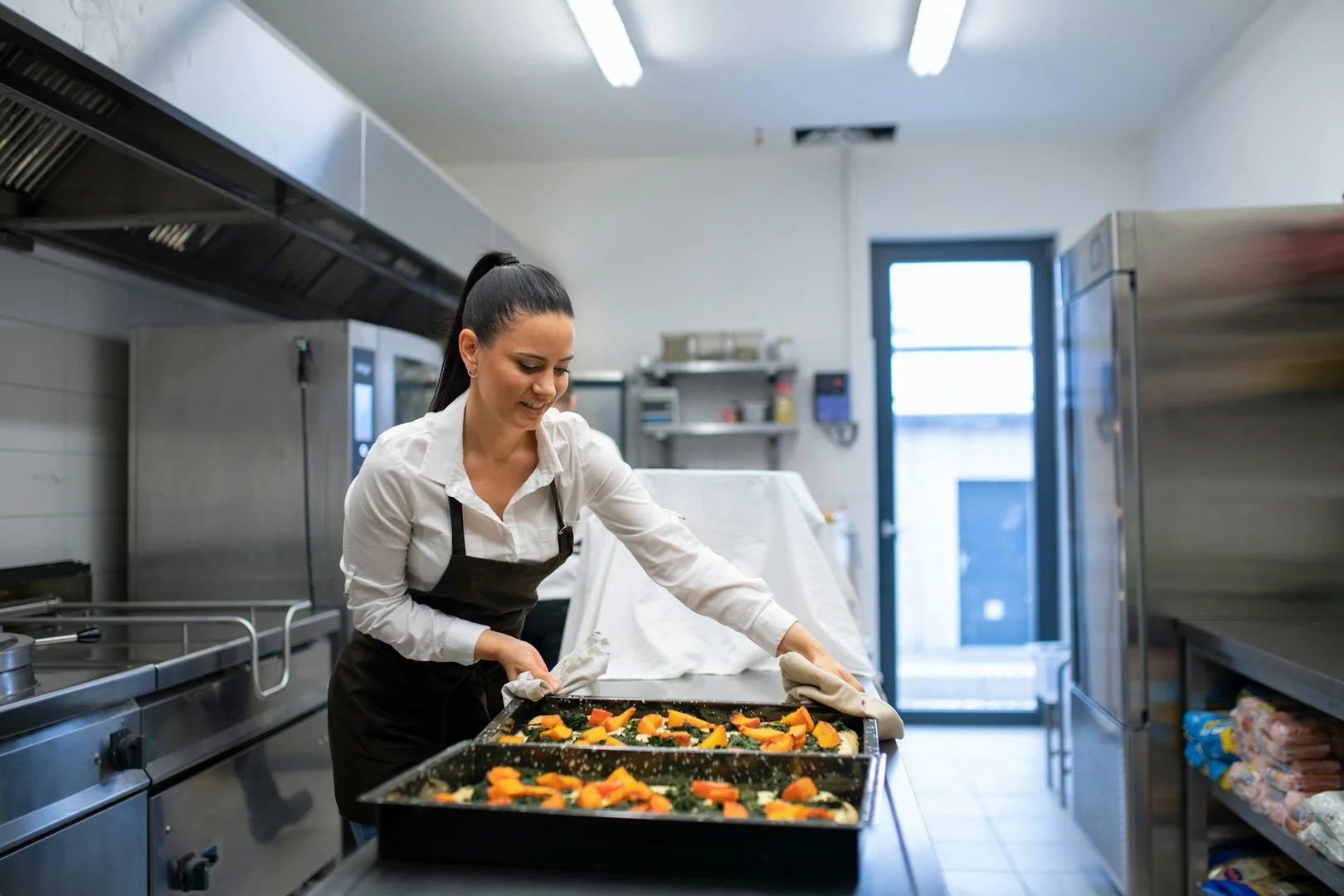 Restaurant staff preparing food for school lunch orders.