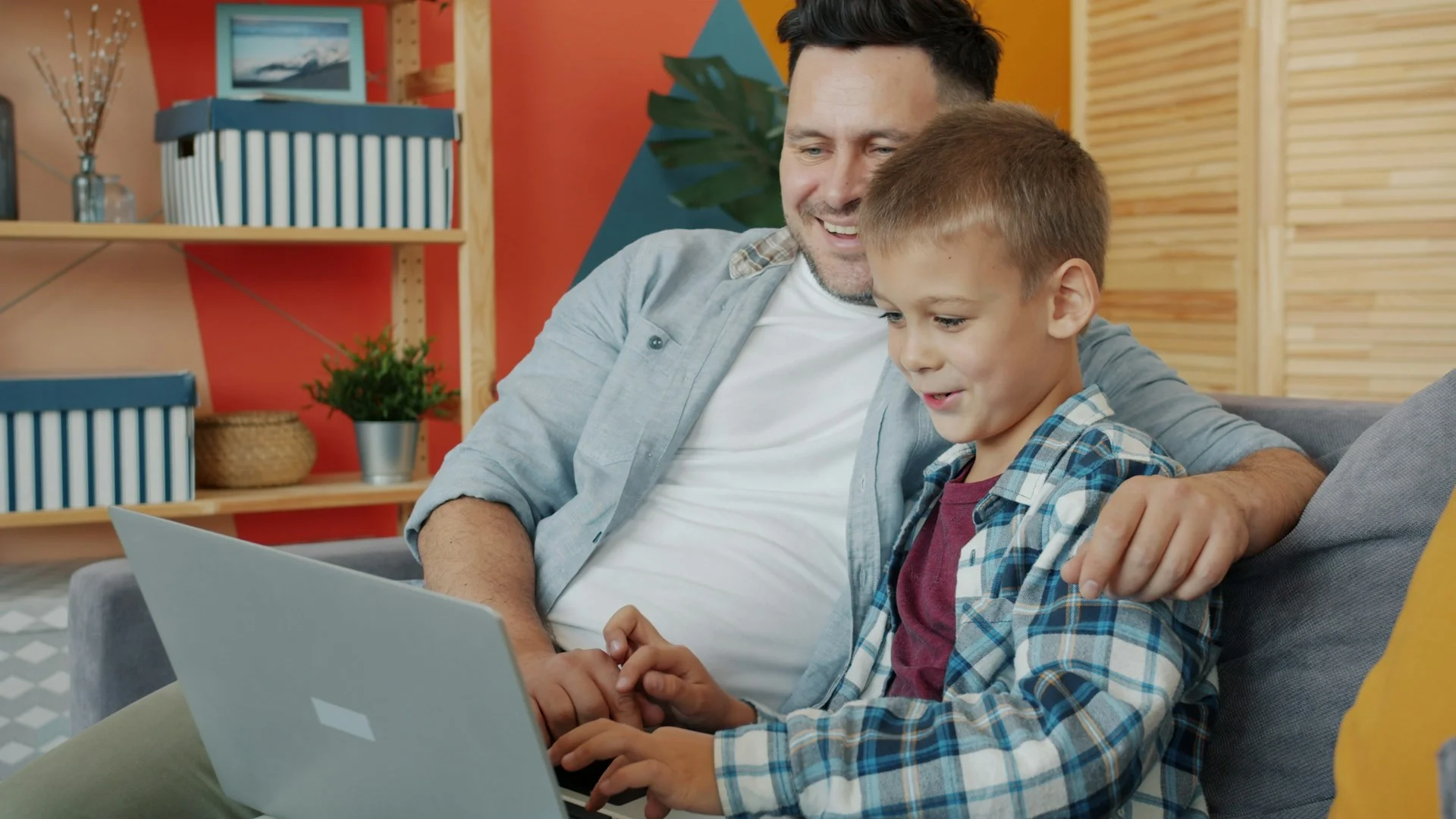 Parent and child using a laptop to place an online school lunch order.