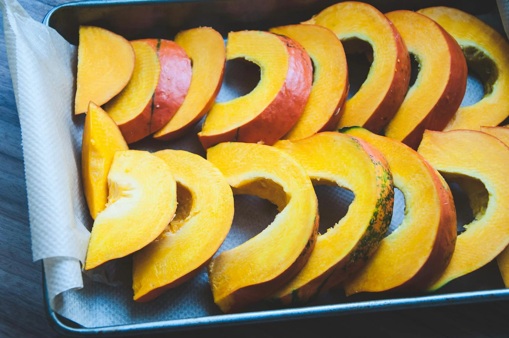 Pre-cut slices of squash arranged on a tray, prepared for batch meal prep.