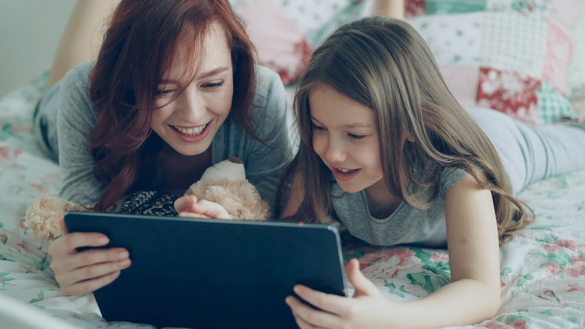 Parent and child reviewing school lunch menu and ordering meals on a tablet.