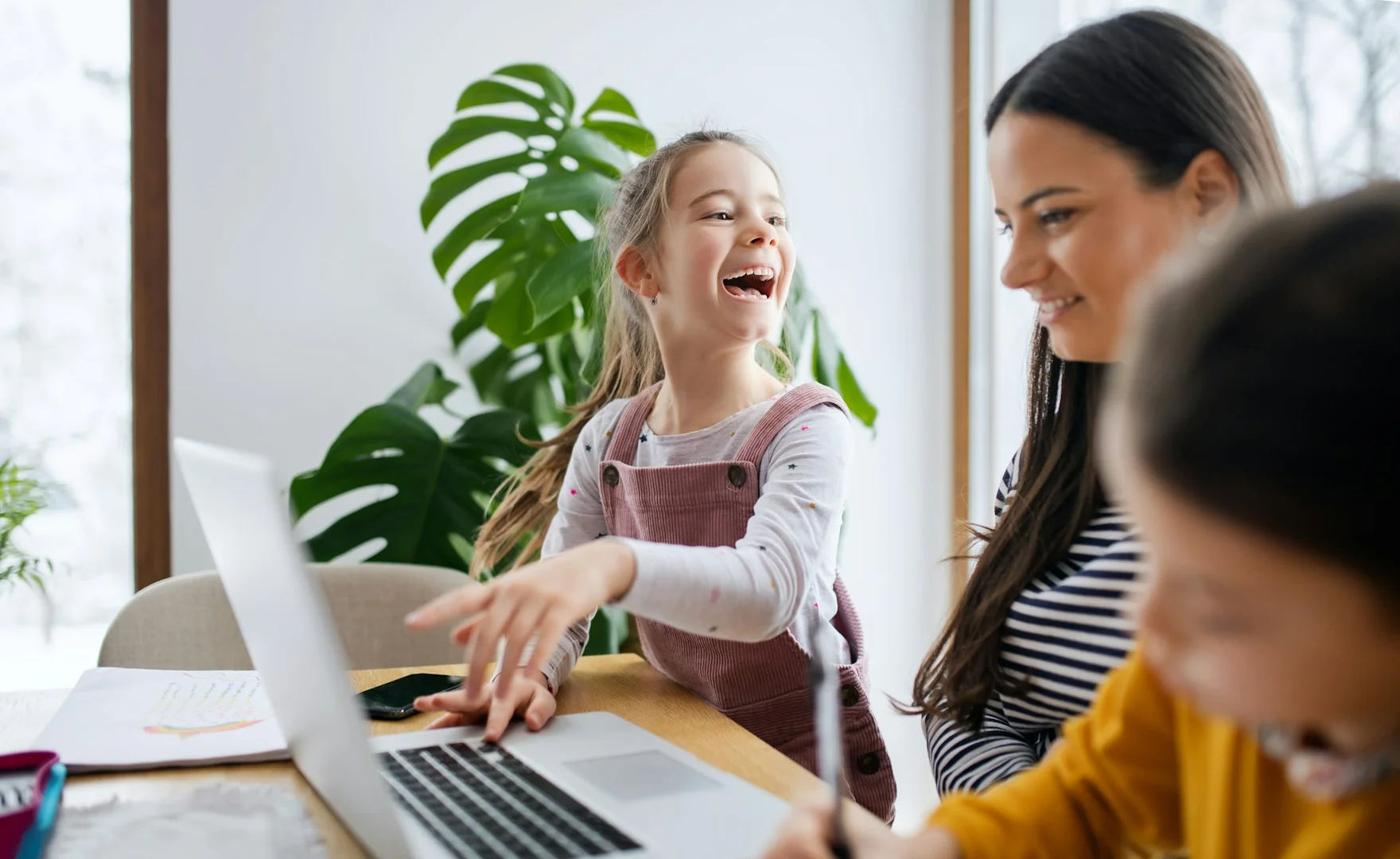 Parent and child using a laptop together to review school lunch program information online.