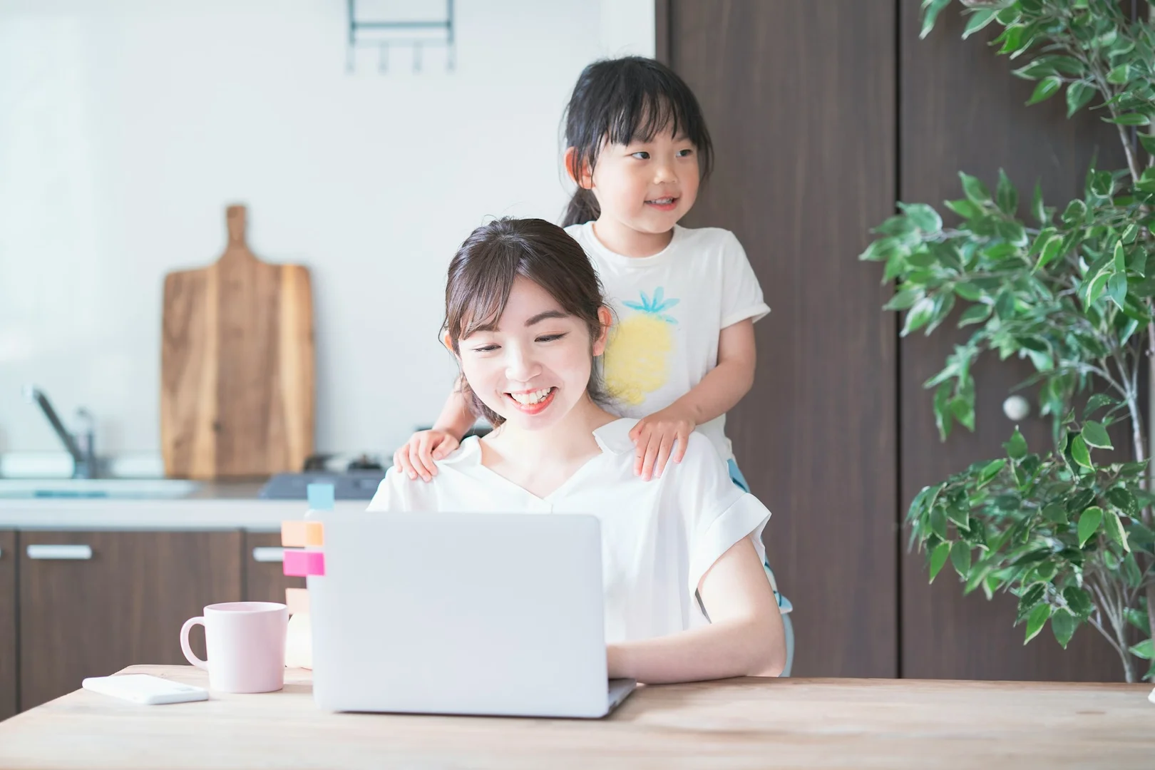 A parent reviewing school lunch program details and updates on a laptop at home.