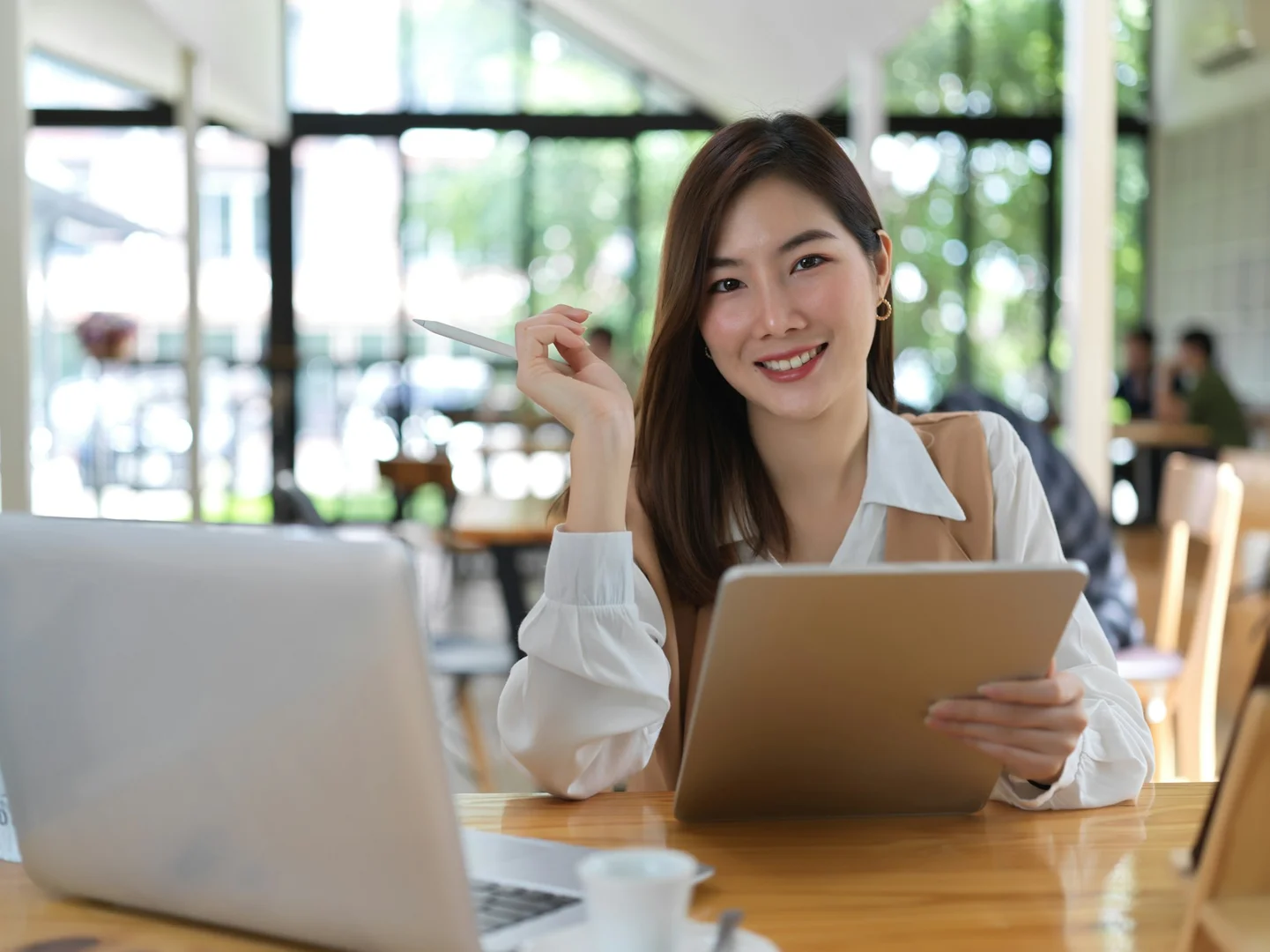 Smiling parent using a tablet to browse an online school lunch ordering system.