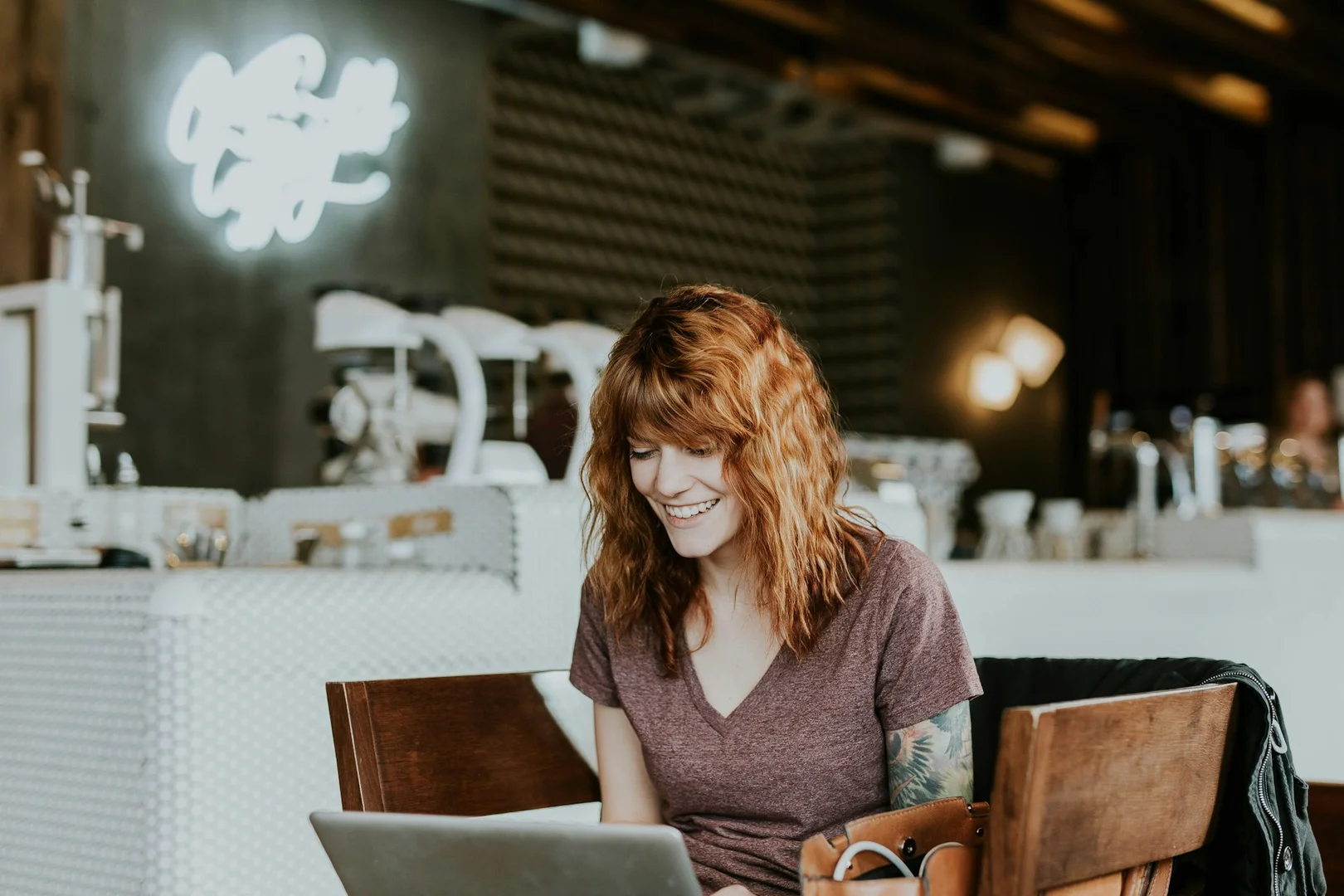 Restaurant owner working on a laptop to coordinate with school lunch program partners.