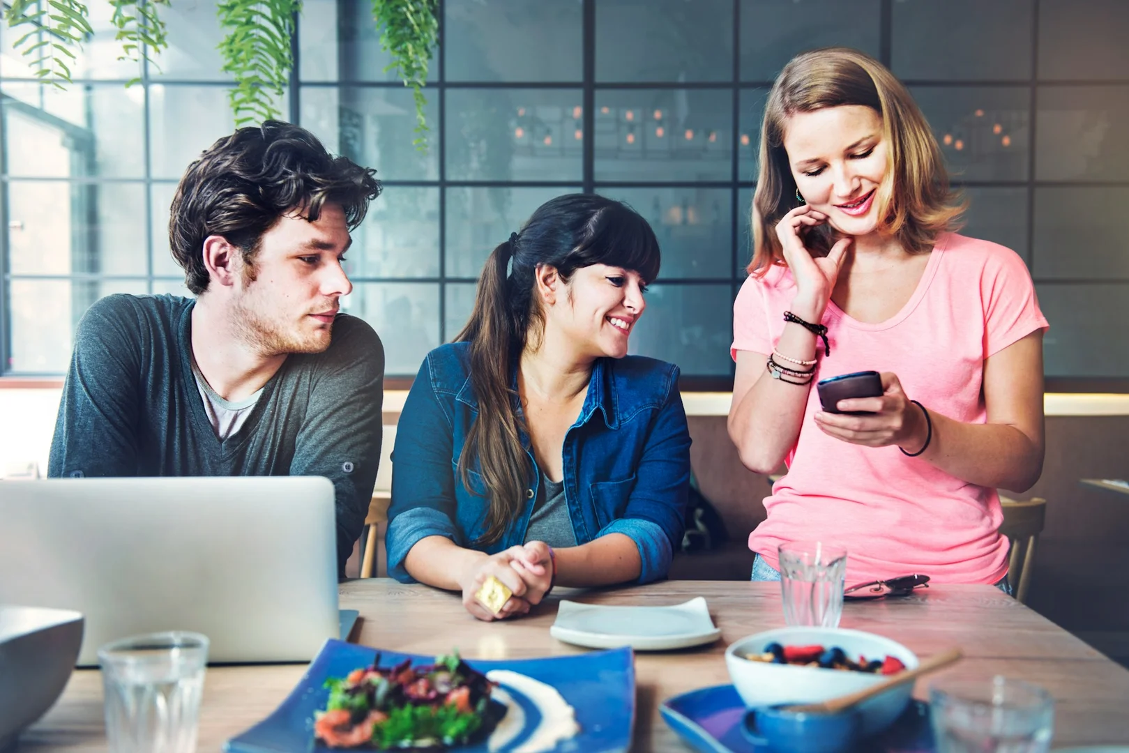Restaurant team reviewing online orders for school lunch program delivery.