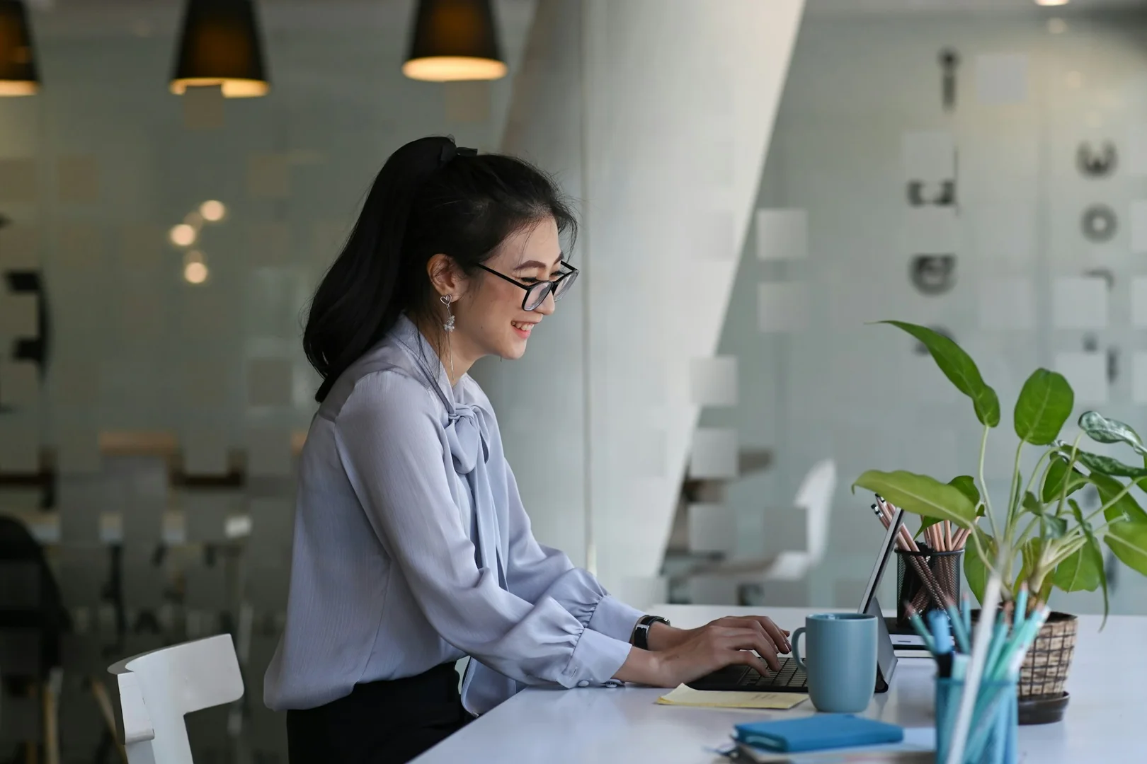 School staff member working on a tablet at a desk, reviewing digital lunch program options.