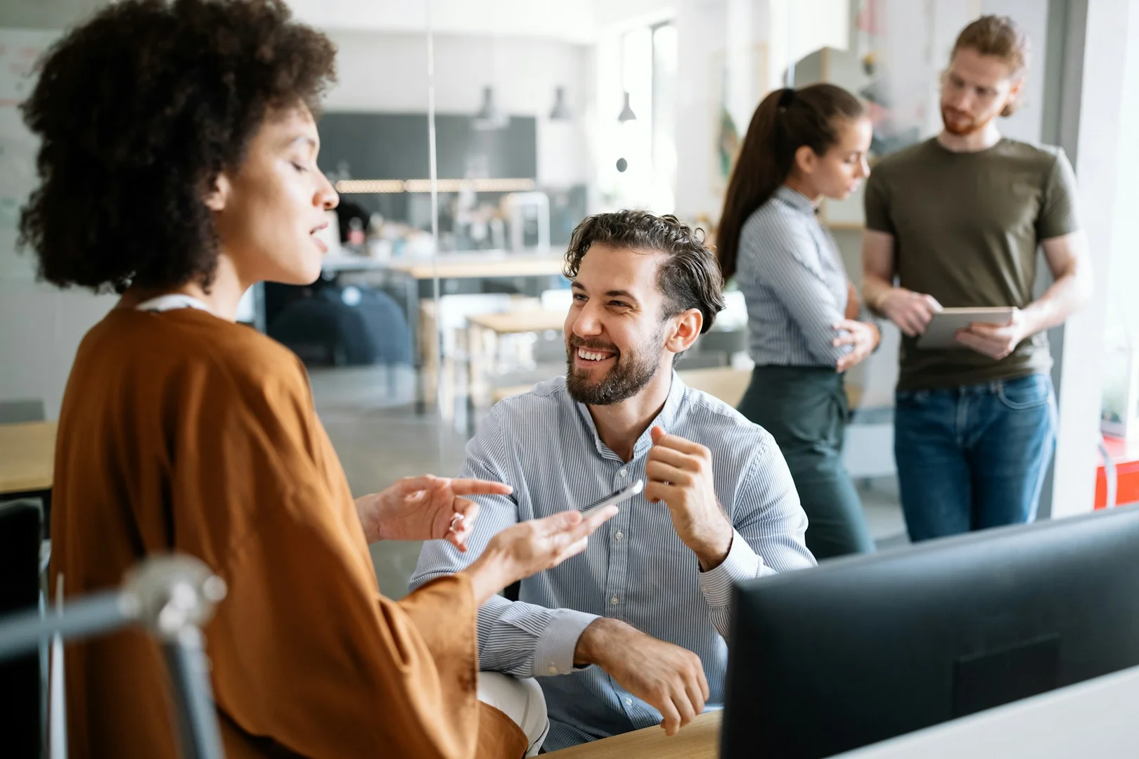 Team members discussing school fundraising platform options during a meeting.