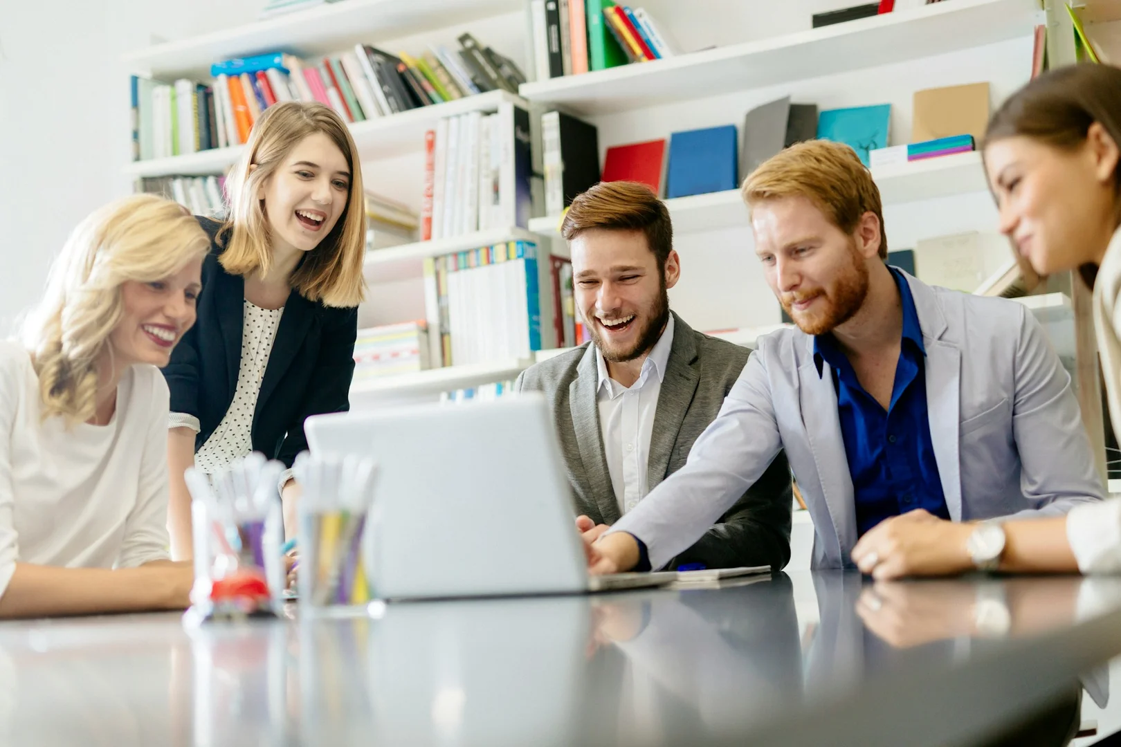 Parent council members reviewing a digital school fundraising platform on a laptop.