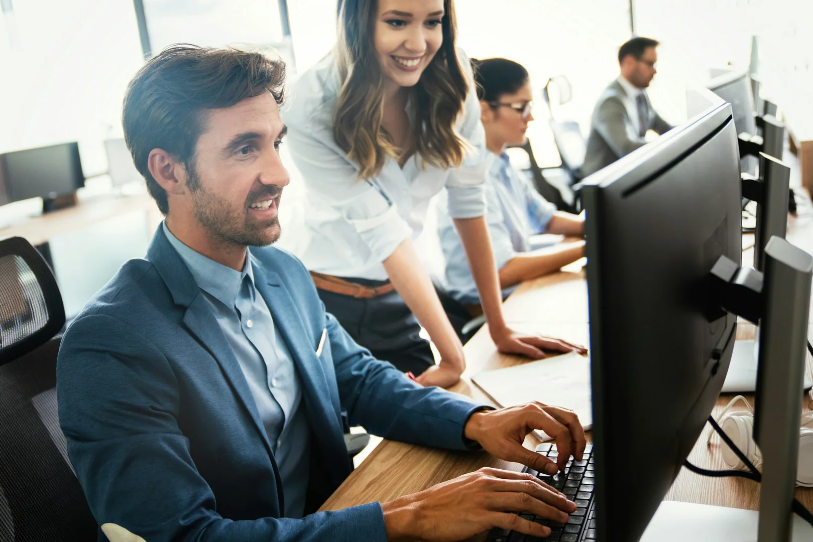 School staff reviewing online fundraising platform features on a computer.