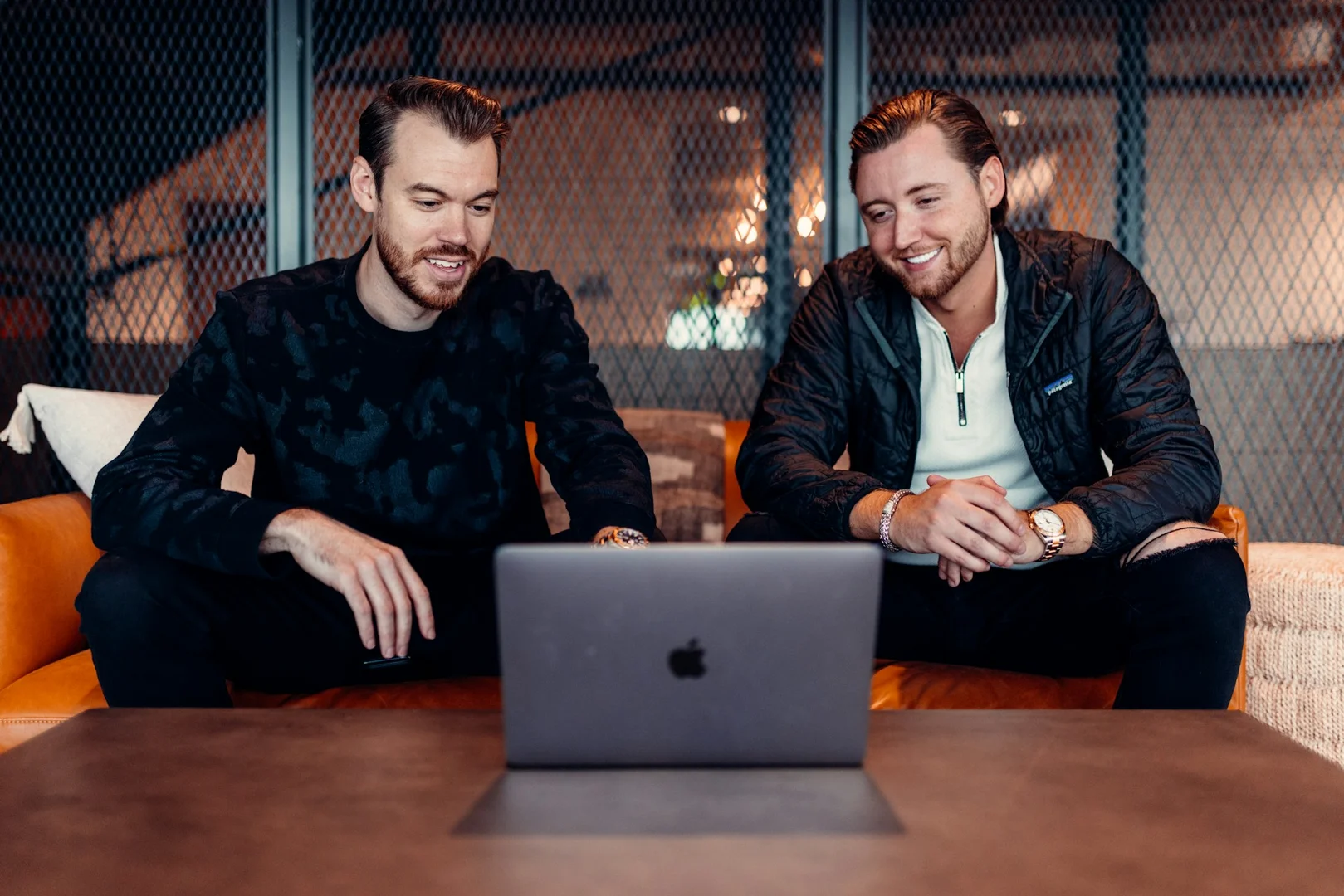 Two people reviewing a school lunch ordering platform on a laptop.