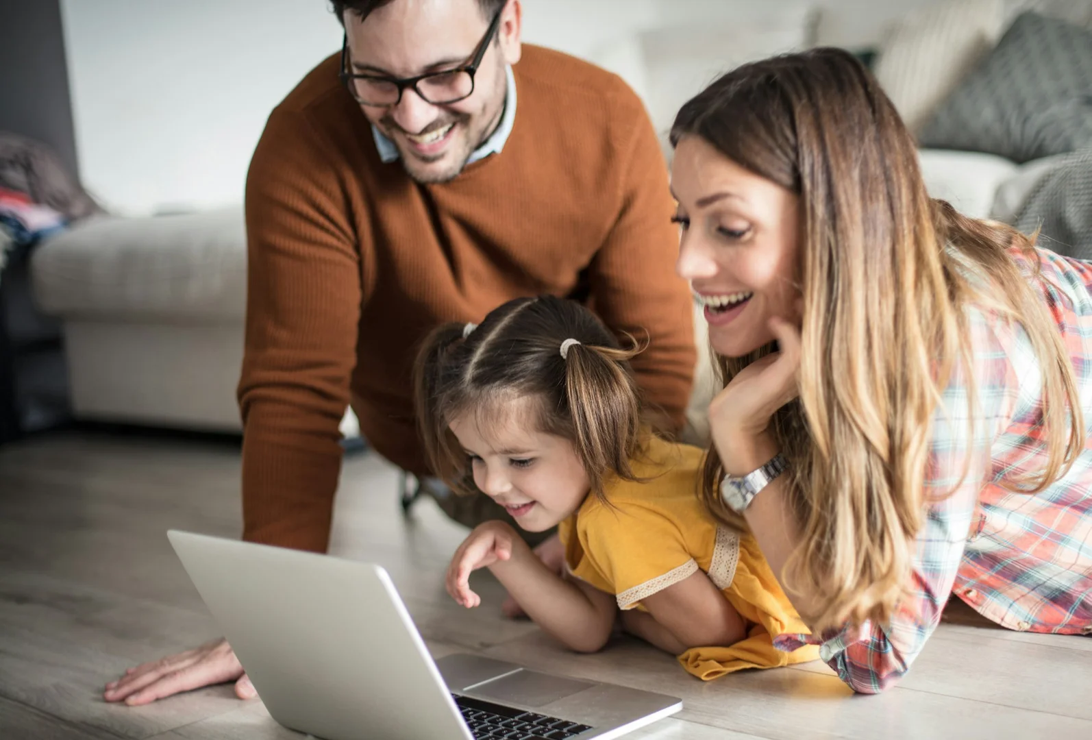 Toronto family using a laptop to manage school lunch orders and meal planning online.